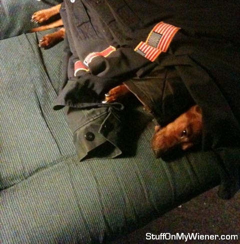 Tubby waits for daddy under his uniforms.